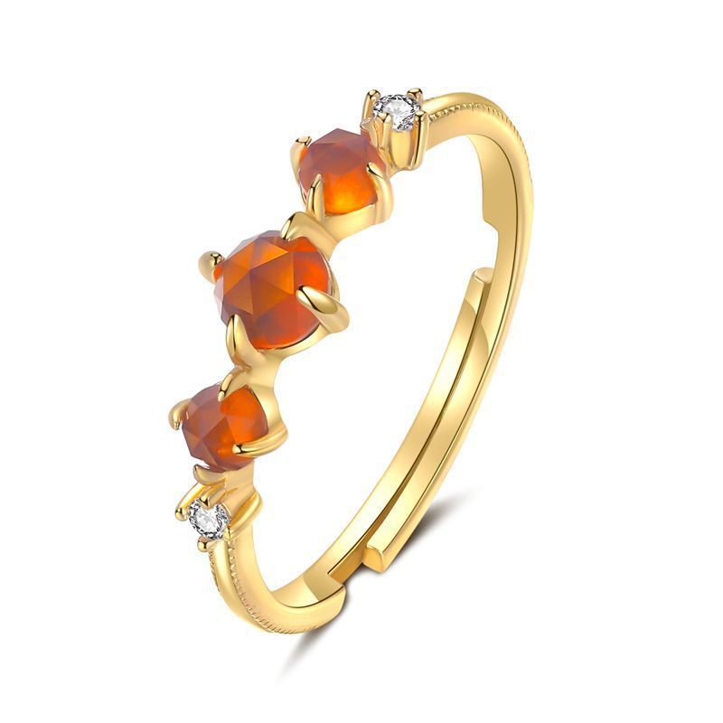 Three orange stone ring on a fine gold-tone band — VoxArcana