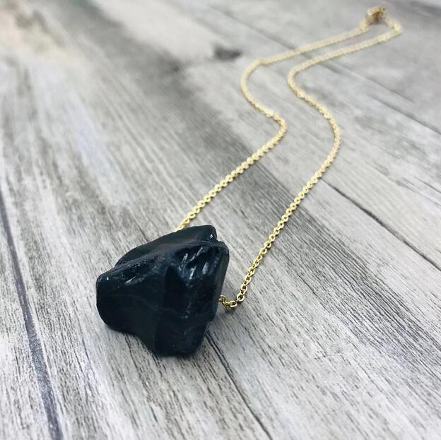 Raw black stone pendant necklace on a gold-tone chain — VoxArcana
